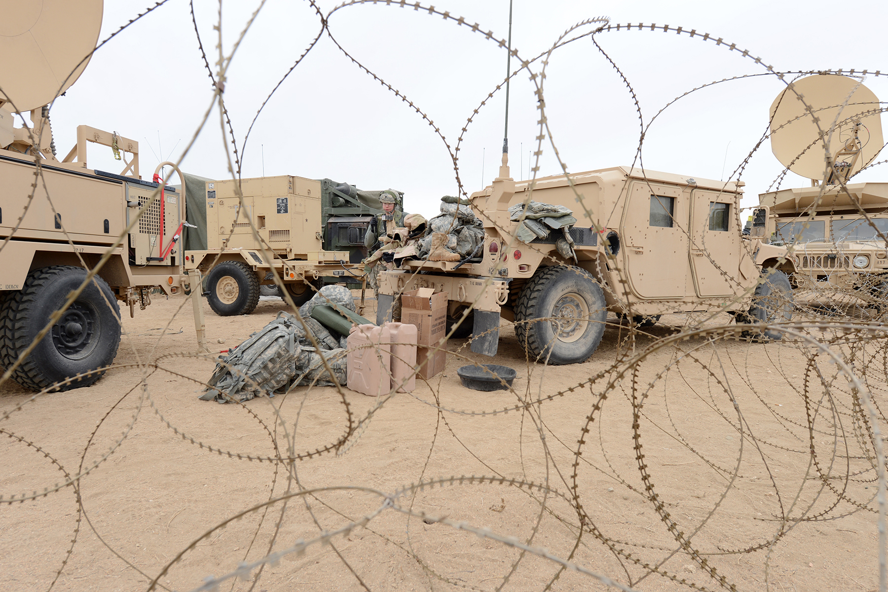 an array of military equipment on display in desert setting