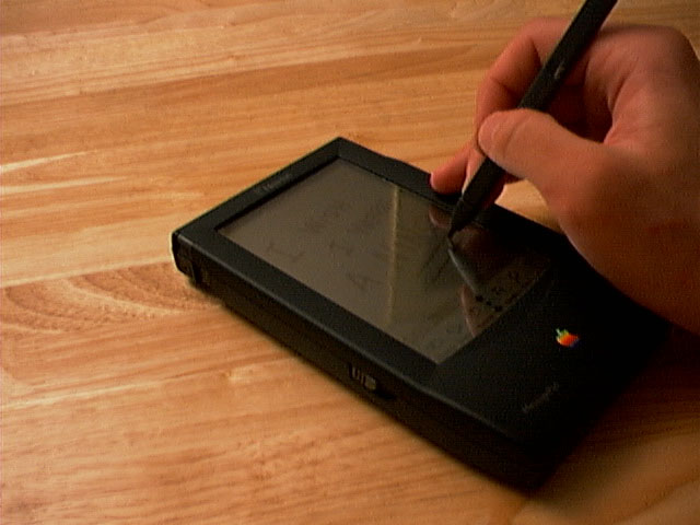 a hand with a pen on a tablet