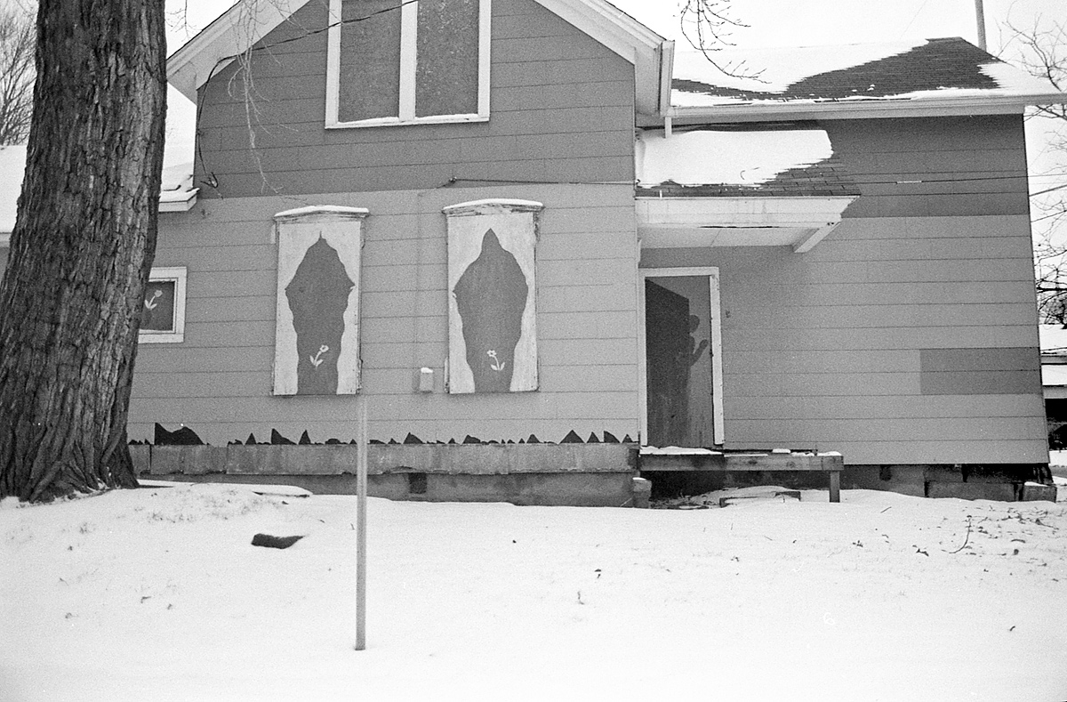 an old house with broken windows and lots of snow