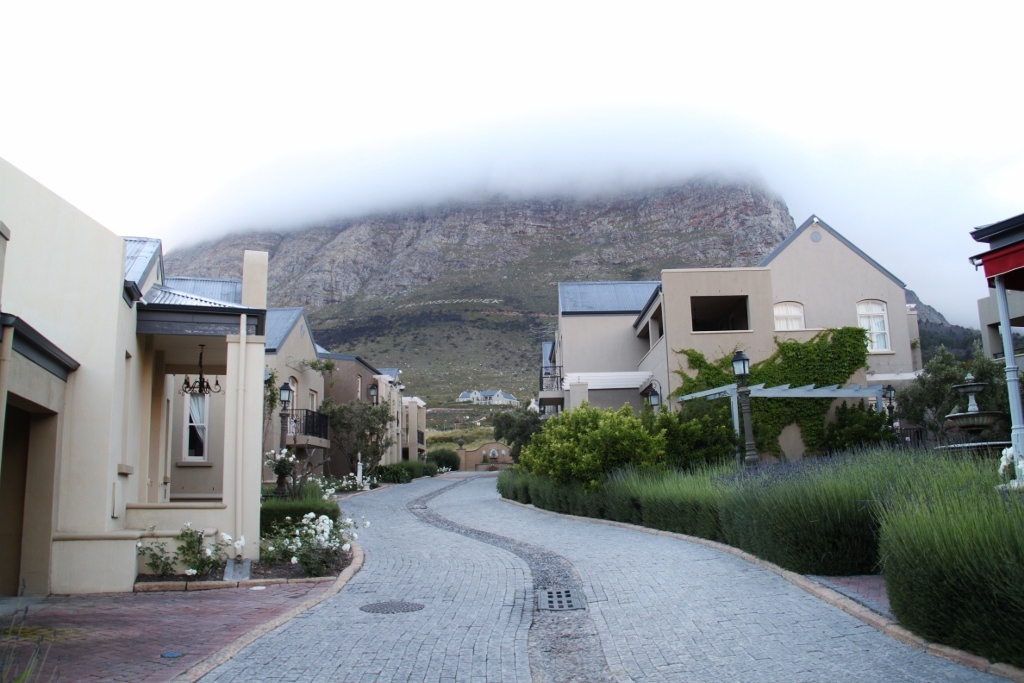 a street on a mountain side with houses next to it