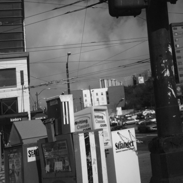 street with telephone poles and signs in front of buildings