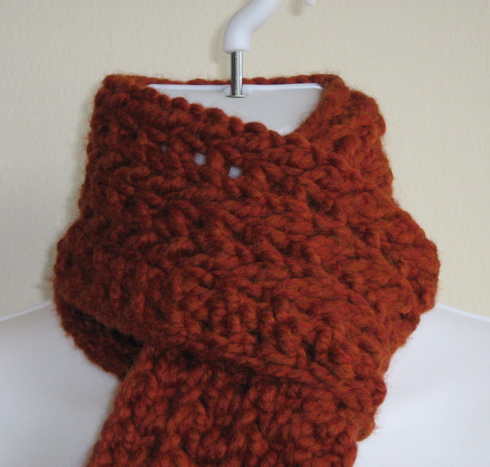 a knit cowl on a display of fabric