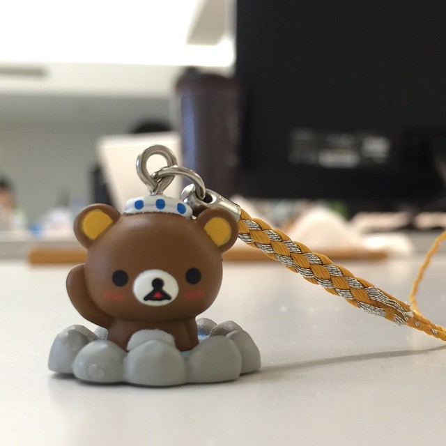 a plastic bear toy key chain attached to a string