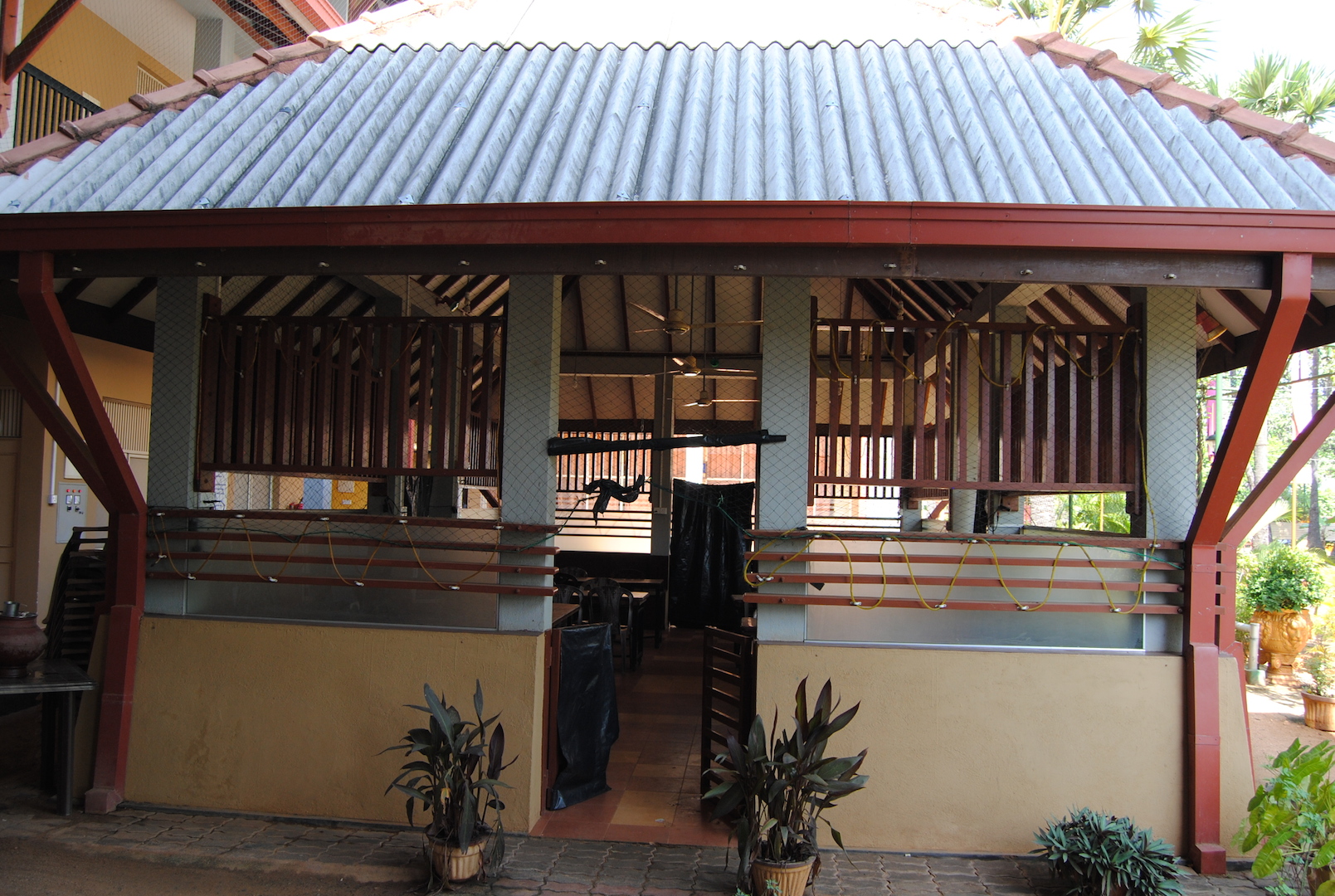 a pavilion with lots of plants surrounding it