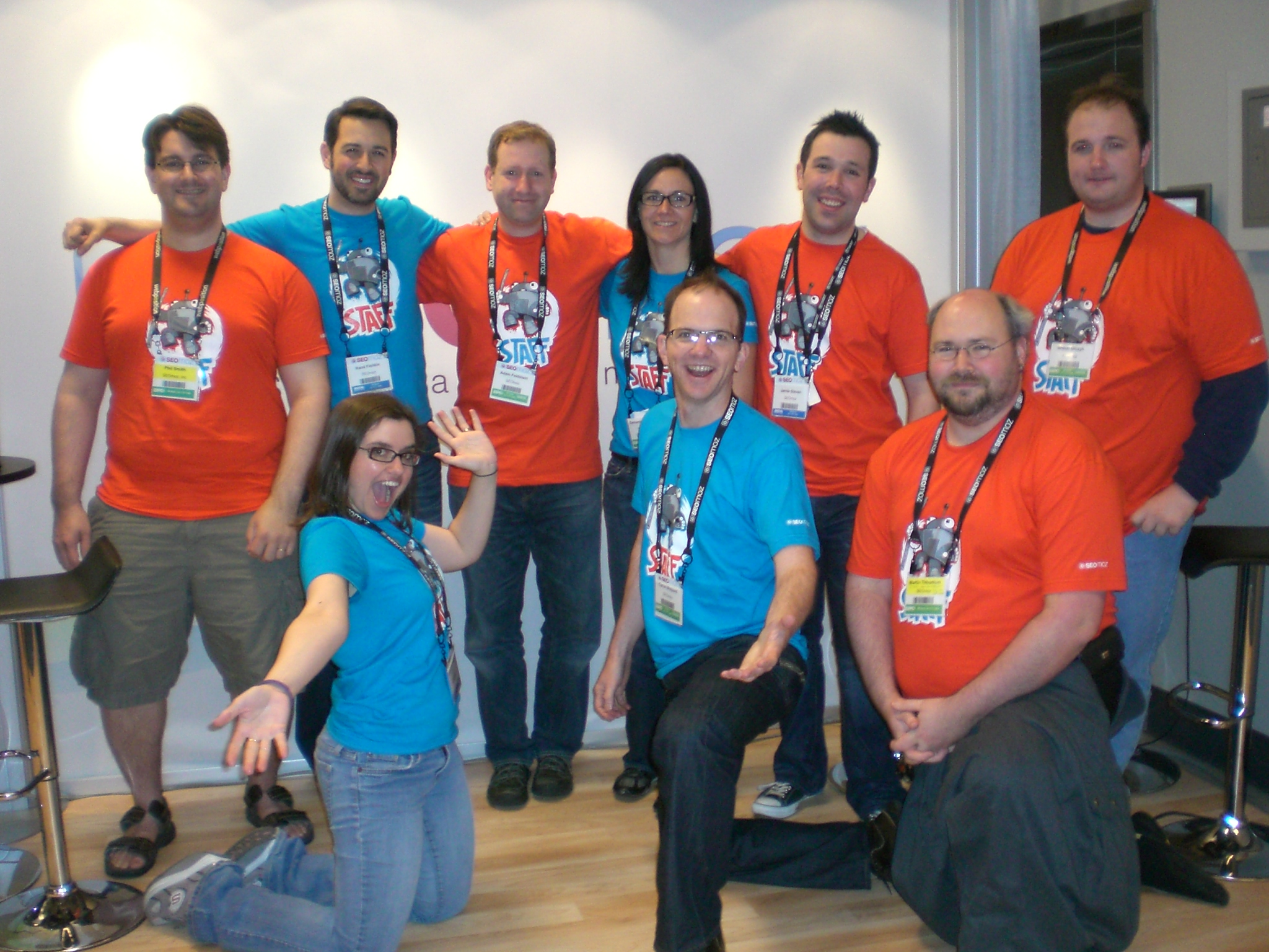 a group of people dressed in matching tshirt standing together