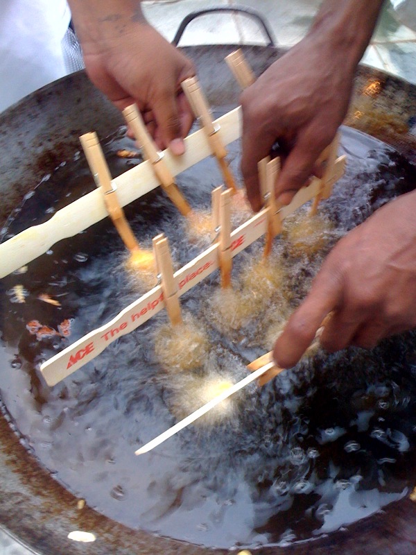 a man placing matches in a metal pot