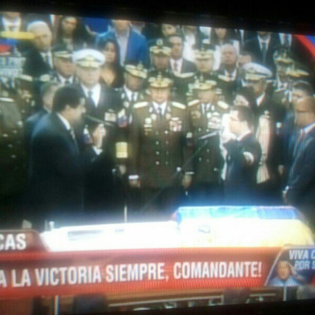 tv screen showing a picture of a military ceremony
