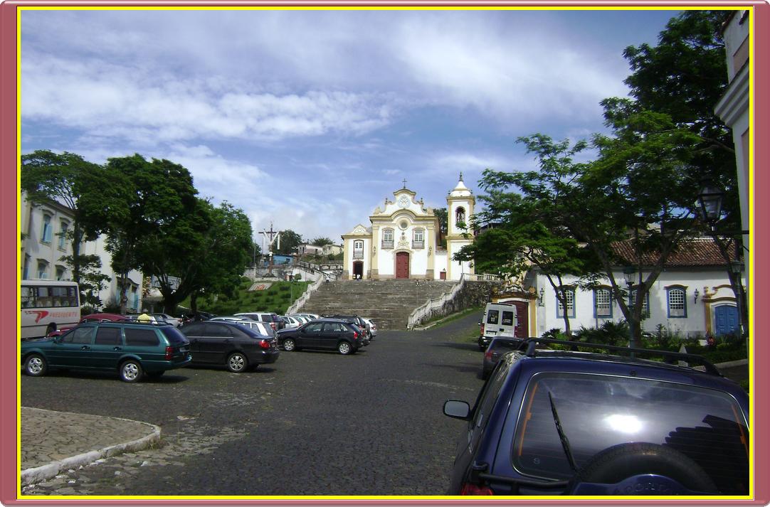 a street with parked cars on it near a church