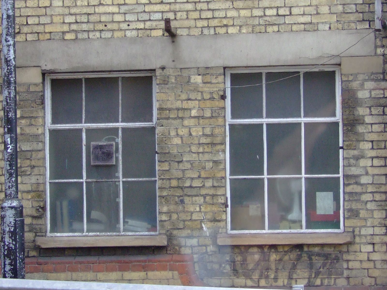 an old building is covered in graffiti and old windows