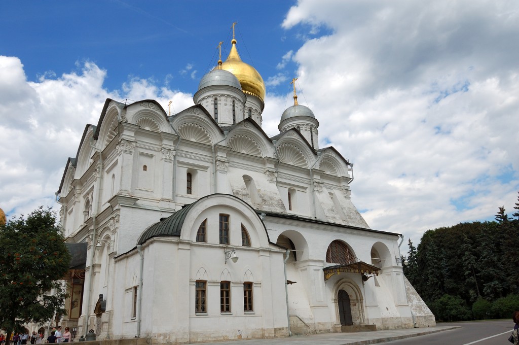 a church with a gold domed dome on a street