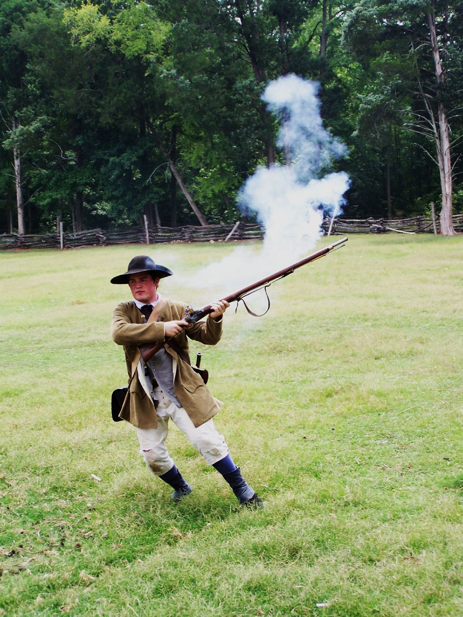 a man in a civil era costume is aiming a rifle at soing