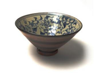 a bowl on a table on which is black and white