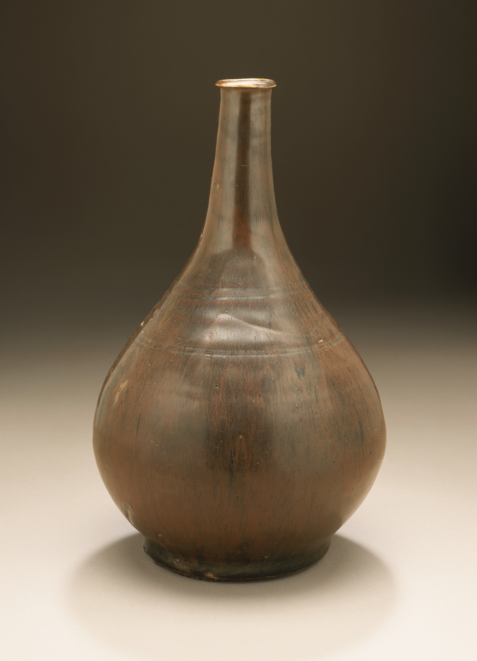 a large brown vase sitting on top of a white counter