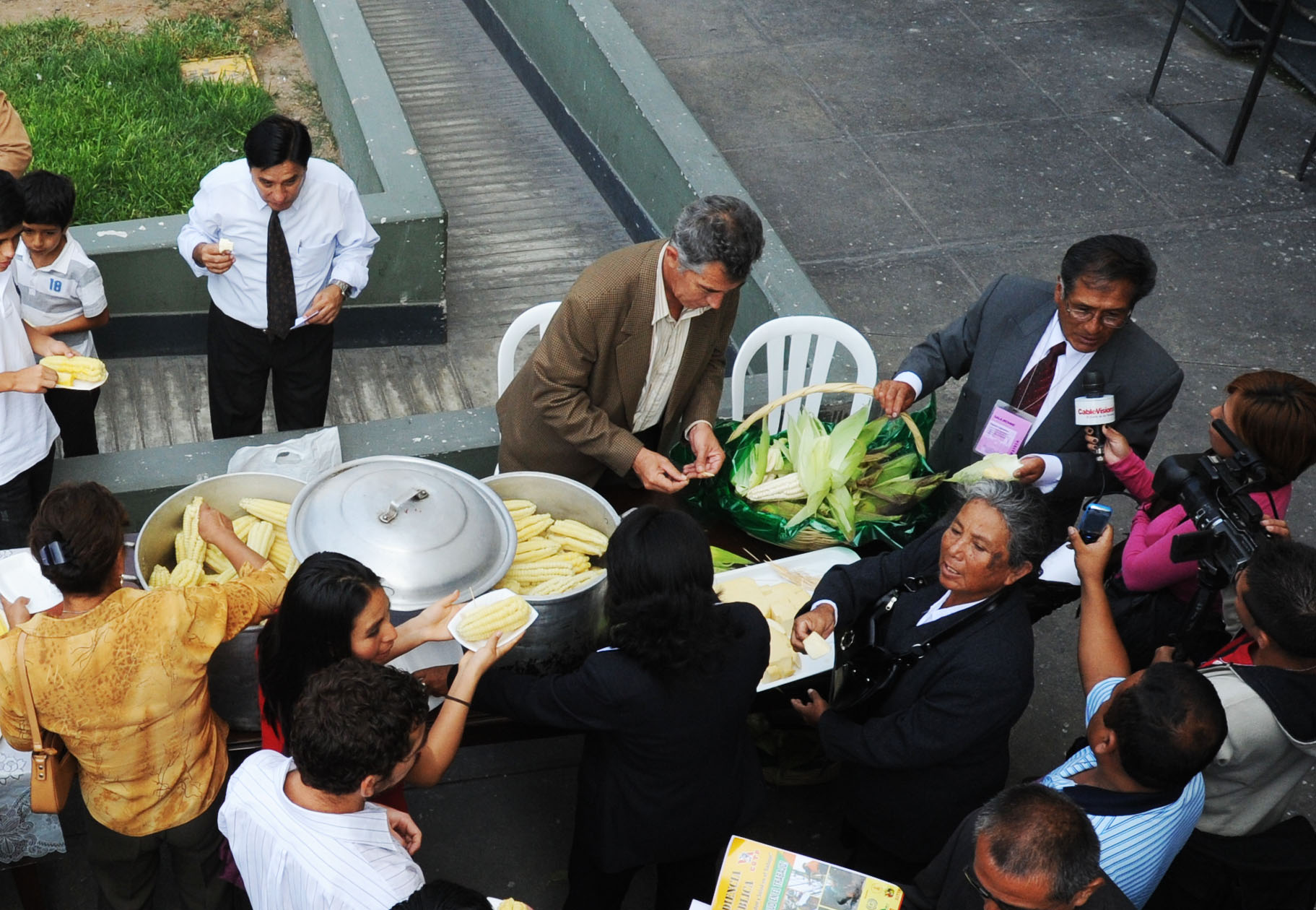 the people are having their plates served on the stairs