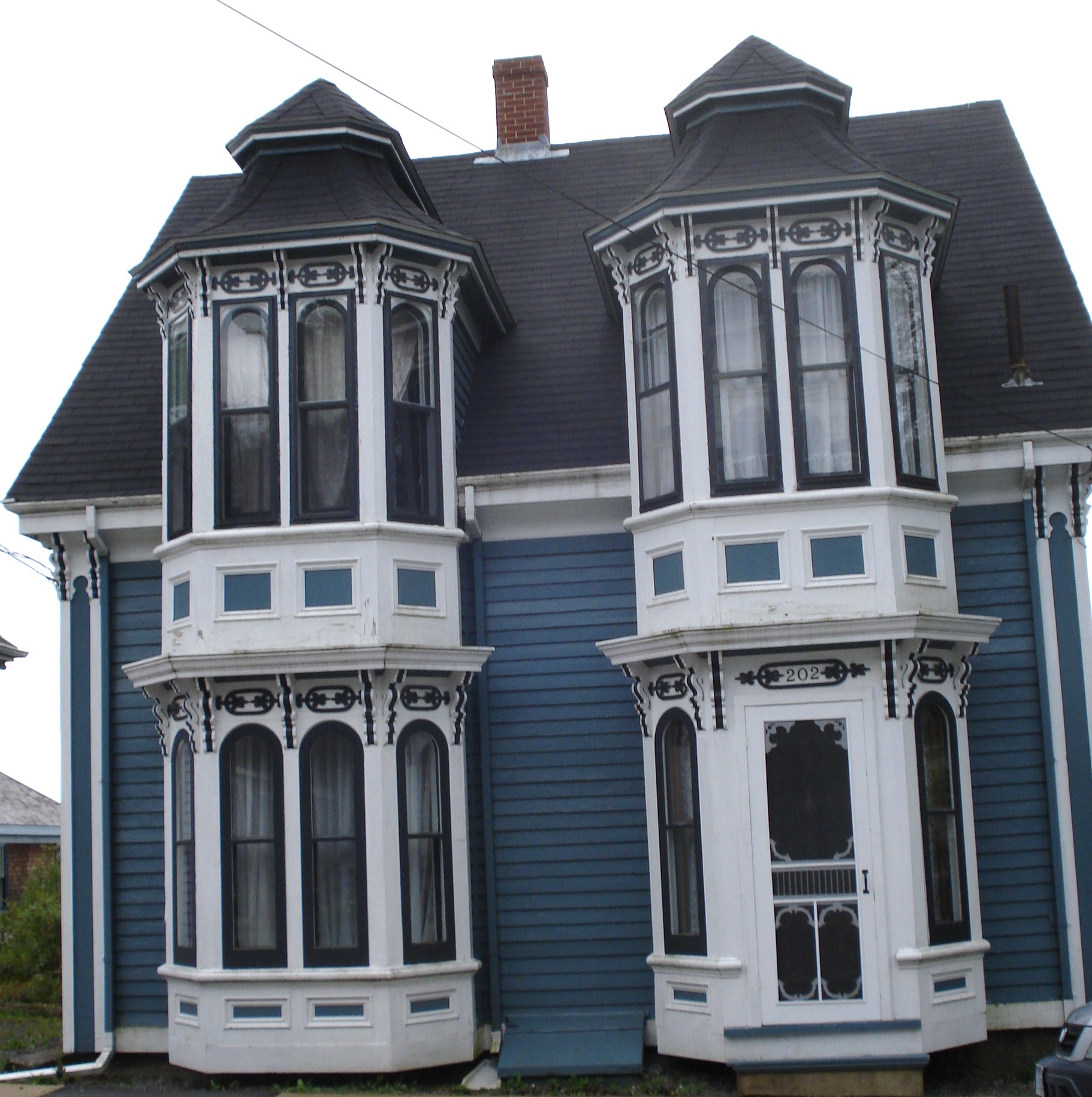 an old victorian house with many windows and balconies