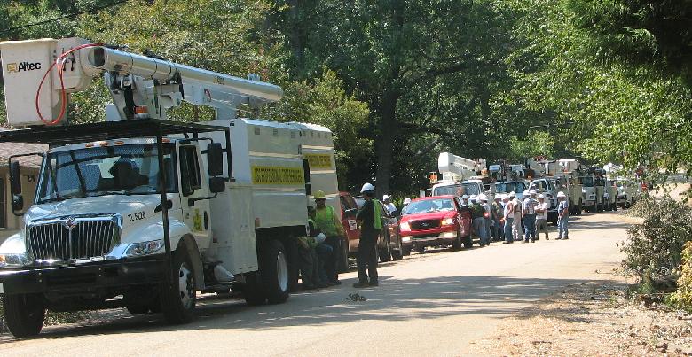 a white truck is holding onto another truck that is going down the road