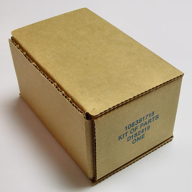 open box on white surface that contains a brown cardboard cover