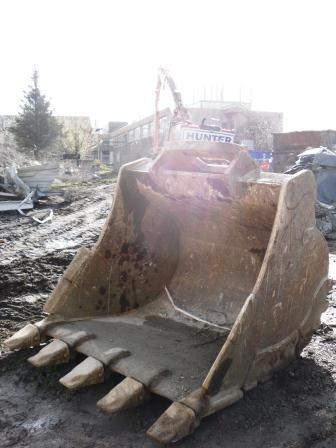 a truck digging on dirt with a big shovel