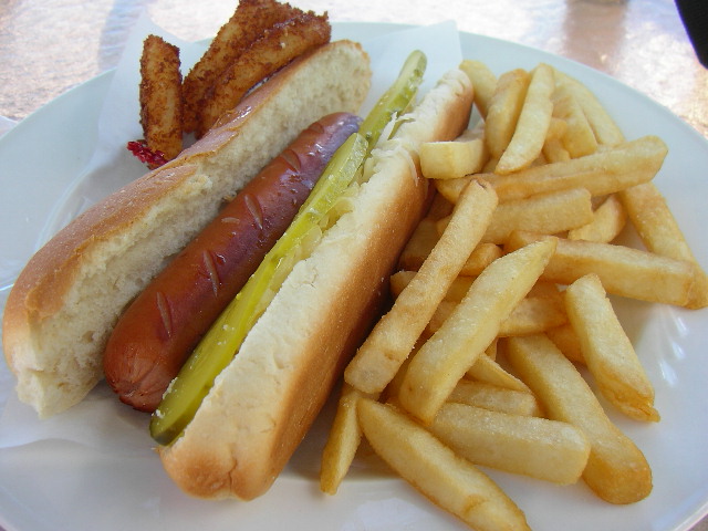 two dogs on a plate with fries