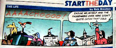 the newspaper has a cartoon strip featuring a woman and man in an office setting