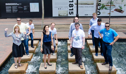 a group of people are standing on stairs over water