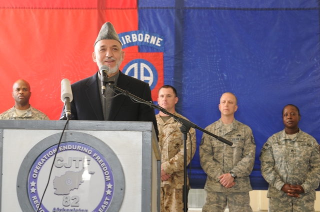 military officials standing around in front of a lectern