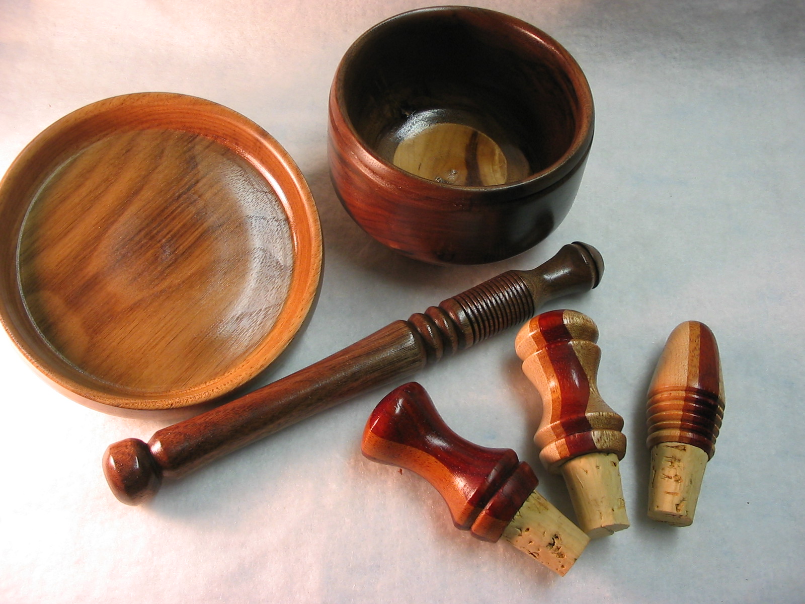 a pair of wine corks and a glass filled with liquid