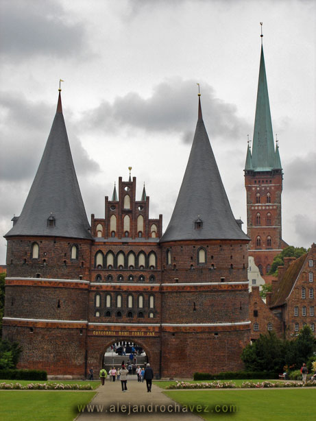 an ornate brick building with two large towers on the top of it