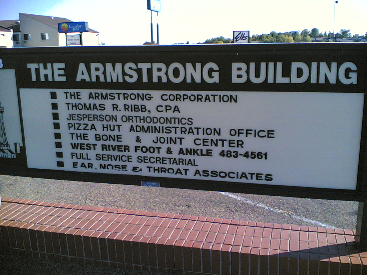 a sign sitting in front of a building