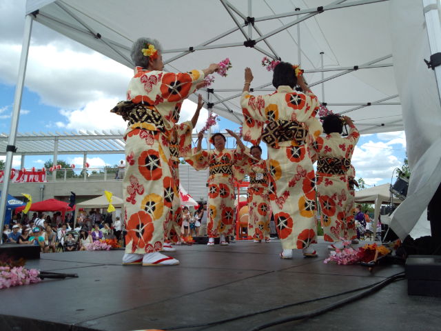 some woman that are standing on a stage