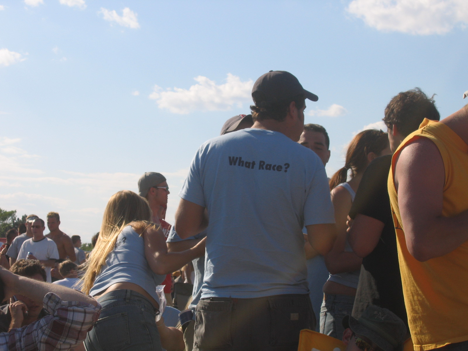 a group of people stand outside by the water