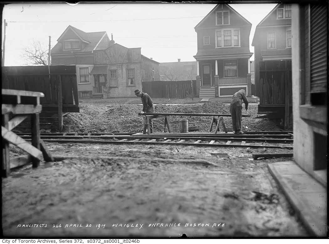 two men working on railroad tracks outside a small town