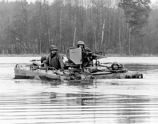 two soldiers sitting on a boat in the water