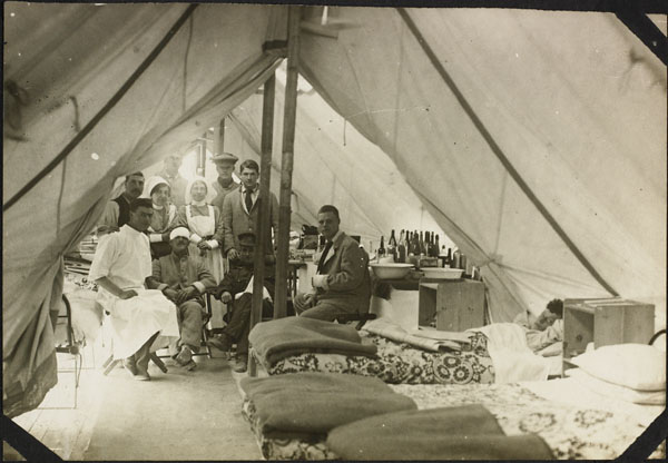 a group of men sitting inside of a tent