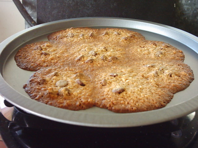 two large cookies are being made on the stove