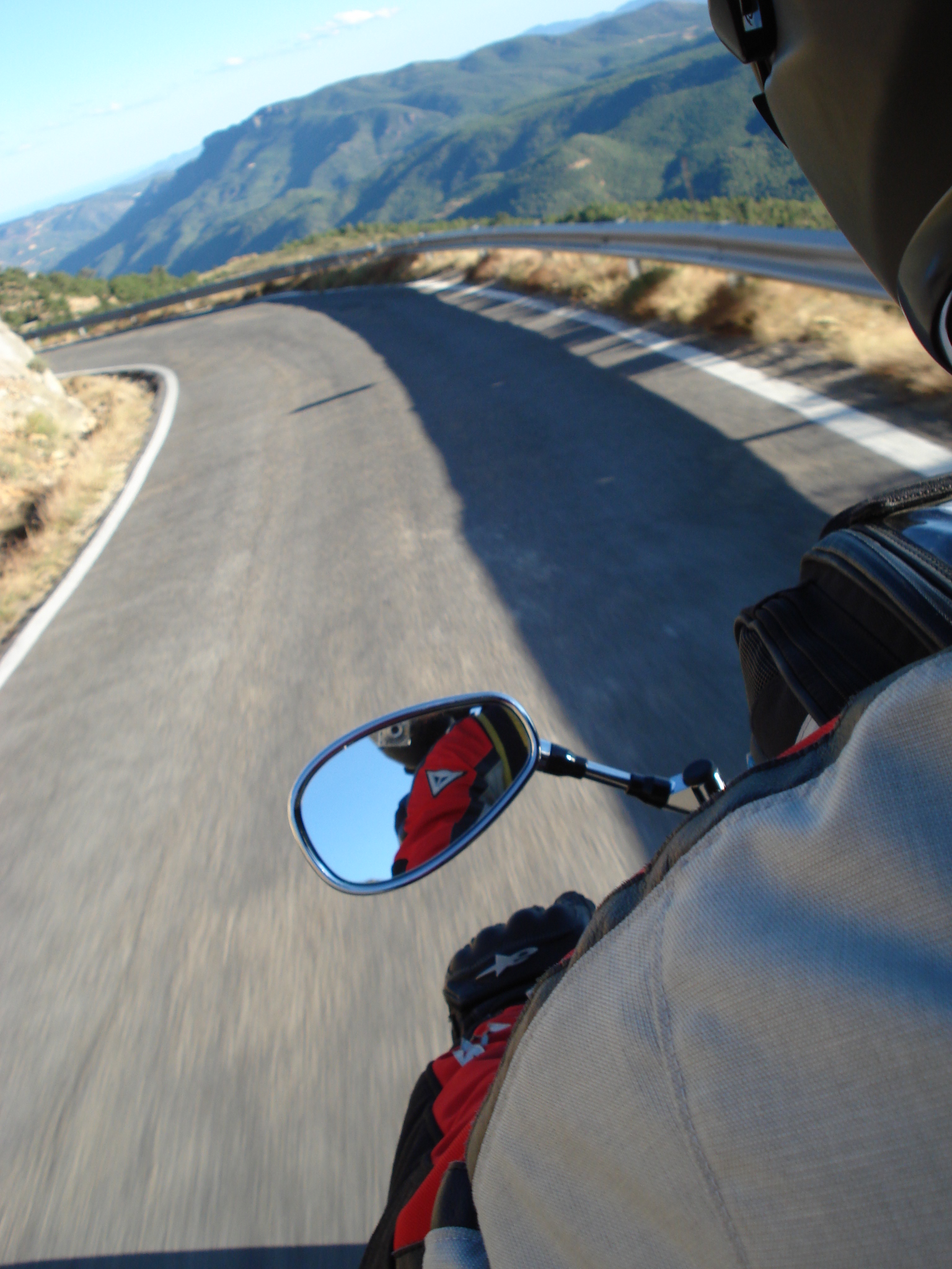 a man riding a motorcycle down a winding road