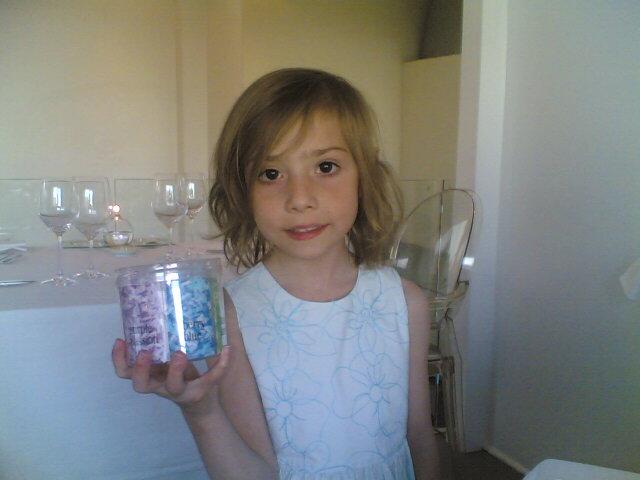 a girl holding a jar full of drinks