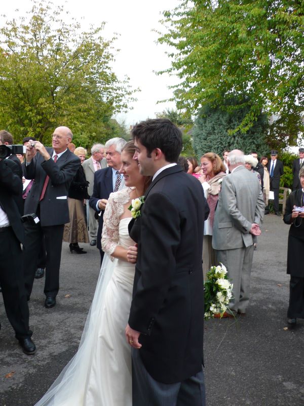 an elegant wedding couple are pictured here in front of cameras