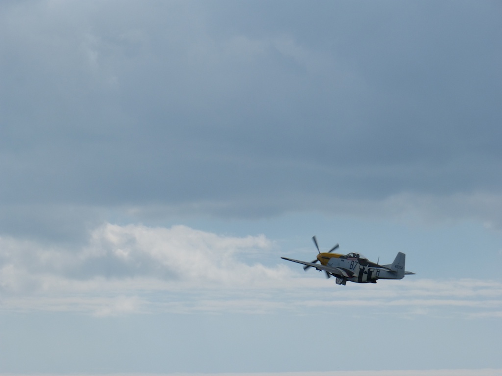 an airplane is flying by on a cloudy day