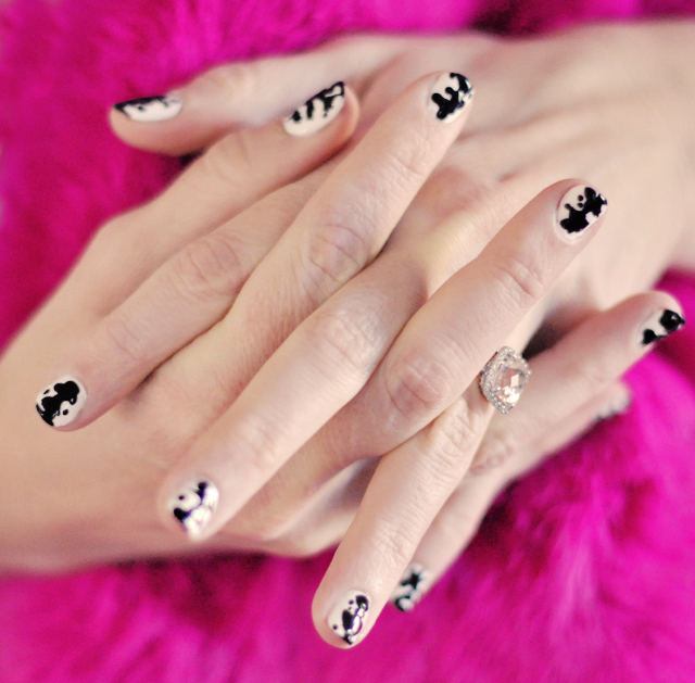 there is a person wearing black and white nail designs