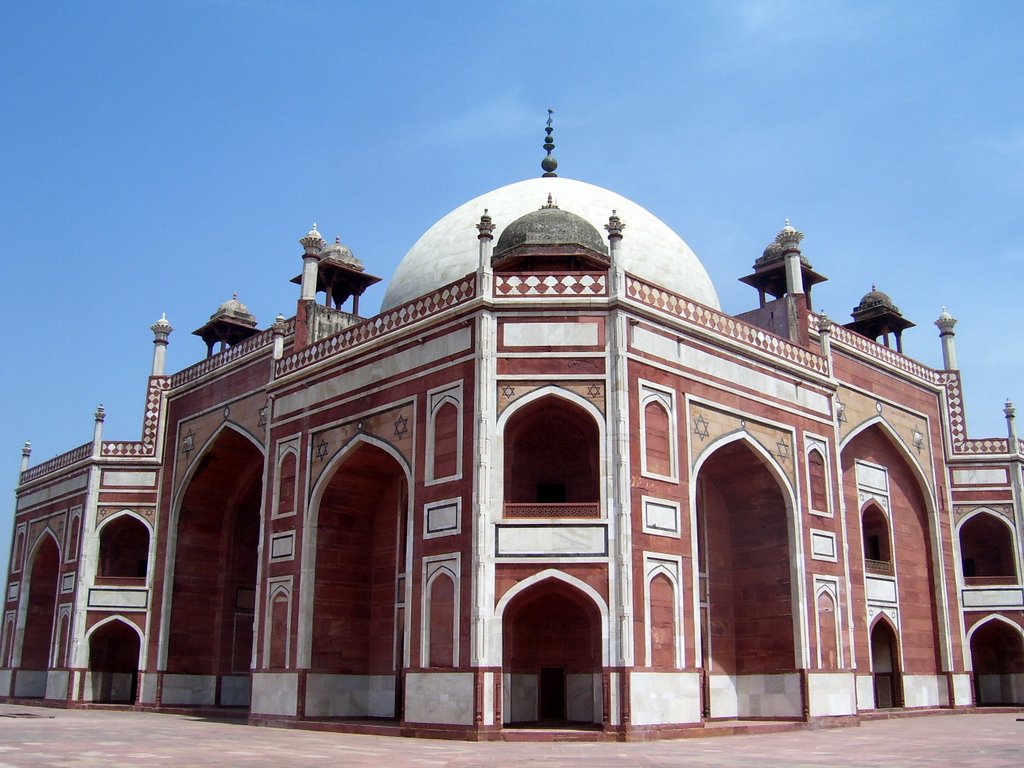 an intricate brick building with domed roof and dome lights on top