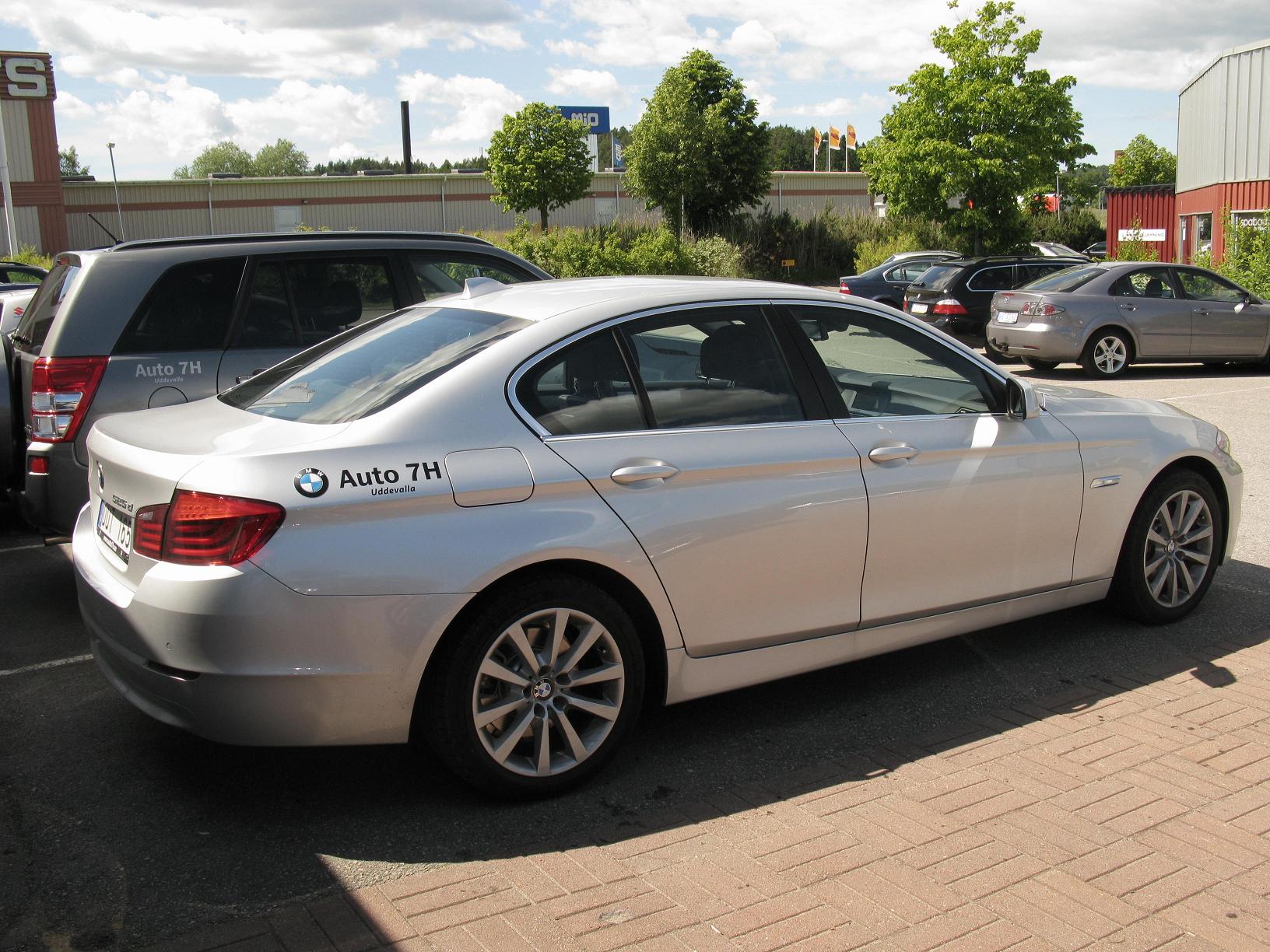 a silver car parked in front of another car