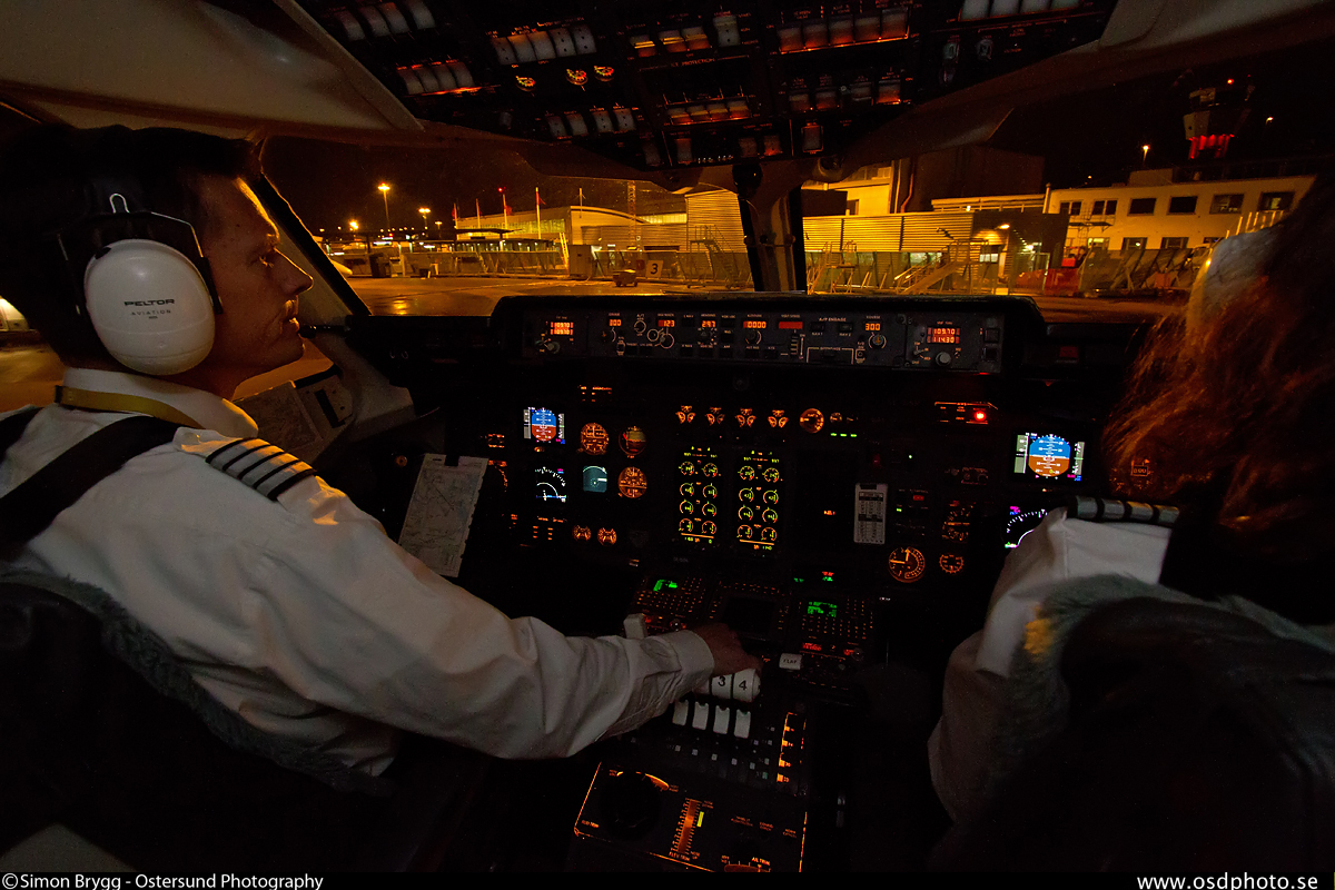 a couple of people in an airplane on a runway