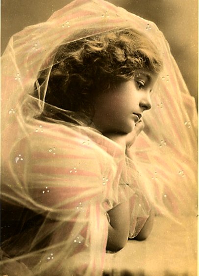 an old black and white po shows a woman in her wedding dress with veil covering her