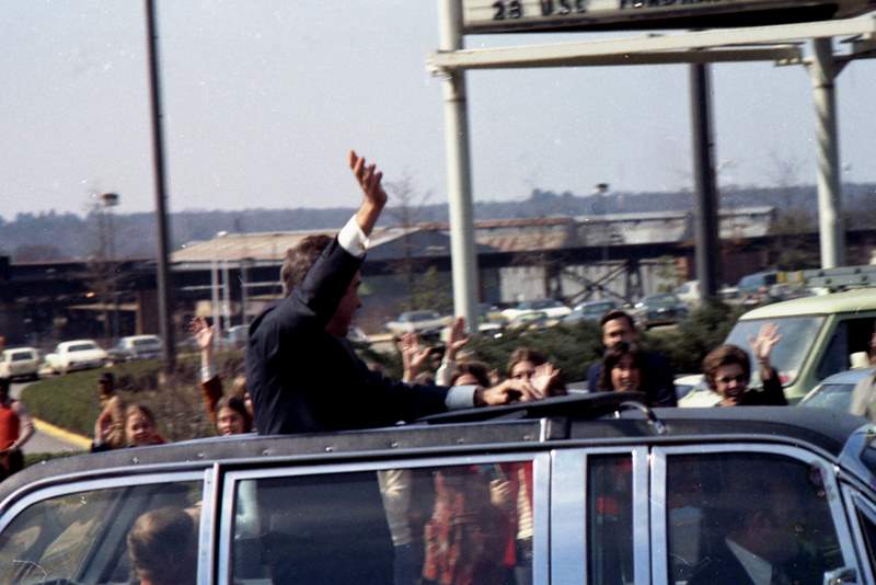 a man is waving to his friends in a jeep