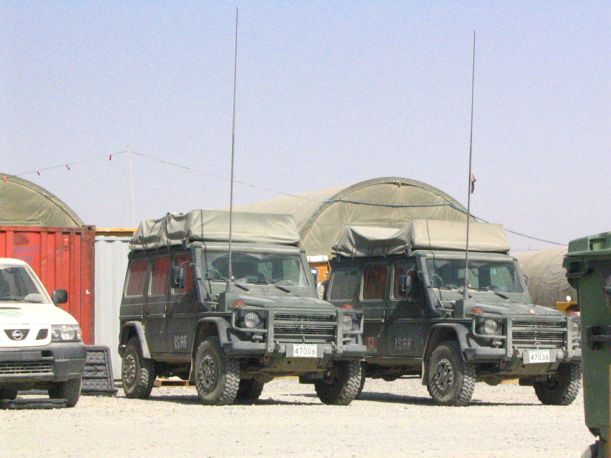 there are several trucks parked on the side of a road