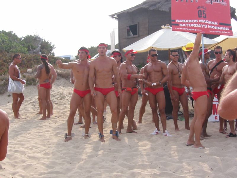 there are many male and female  strippers on the beach