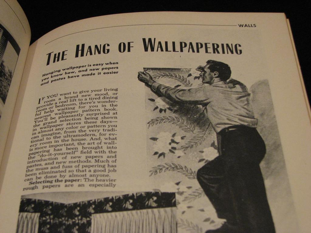 an old book showing the hands of wallpapering
