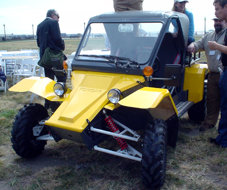 a yellow vehicle on display at an outdoor event
