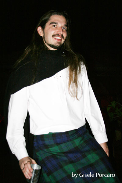 a man in a kilt is standing up